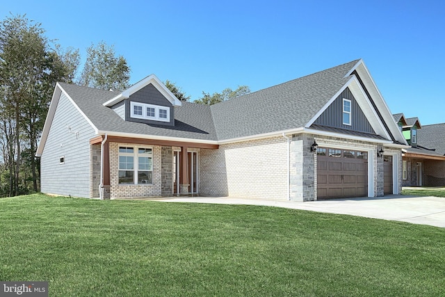 567 Lumber St, Littlestown, PA 17340 - view of front of house with driveway, a front lawn, board and batten siding, brick siding, and an attached garage