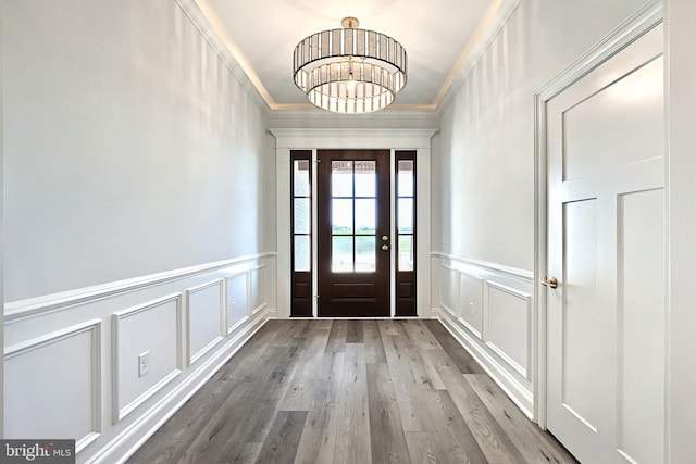 567 Lumber St, Littlestown, PA 17340 - entryway with a decorative wall, wood finished floors, wainscoting, a chandelier, and crown molding