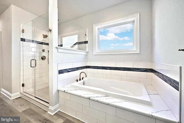 567 Lumber St, Littlestown, PA 17340 - full bath with a stall shower, wood finished floors, a bath, and baseboards