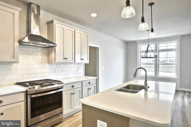 567 Lumber St, Littlestown, PA 17340 - kitchen with gas stove, wall chimney exhaust hood, a sink, tasteful backsplash, and light wood-type flooring