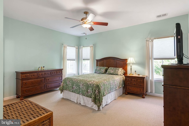 35206 Seagrass Plantation Ln, Dagsboro, DE 19939 - bedroom with light colored carpet, multiple windows, a ceiling fan, and baseboards