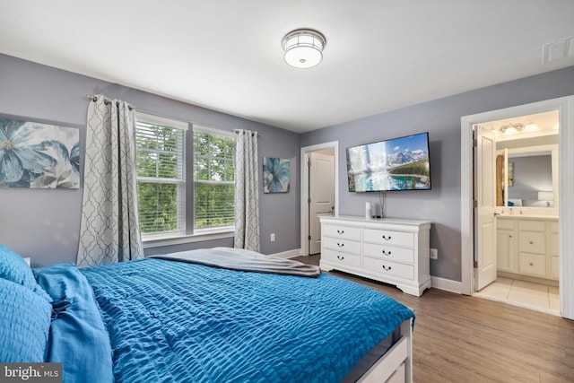 10744 Hinton Way, Manassas, VA 20112 - bedroom with wood finished floors, baseboards, and ensuite bath