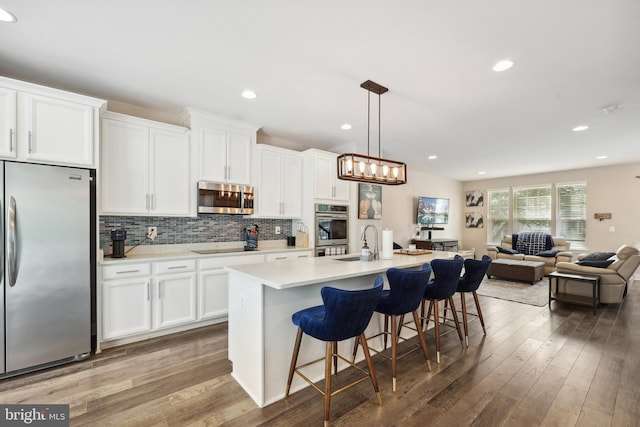 10744 Hinton Way, Manassas, VA 20112 - kitchen featuring appliances with stainless steel finishes, a sink, wood finished floors, white cabinetry, and recessed lighting