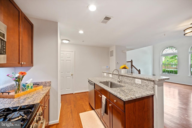 6124 Aster Haven Cir, Haymarket, VA 20169 - kitchen with a sink, stainless steel appliances, light wood finished floors, a center island with sink, and recessed lighting