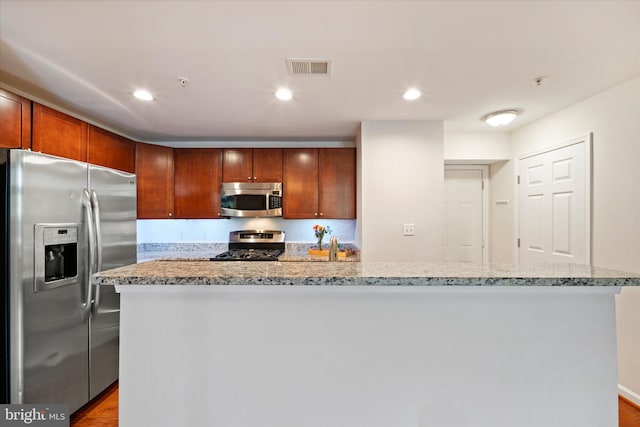 6124 Aster Haven Cir, Haymarket, VA 20169 - kitchen with appliances with stainless steel finishes, wood finished floors, light stone counters, a center island with sink, and recessed lighting
