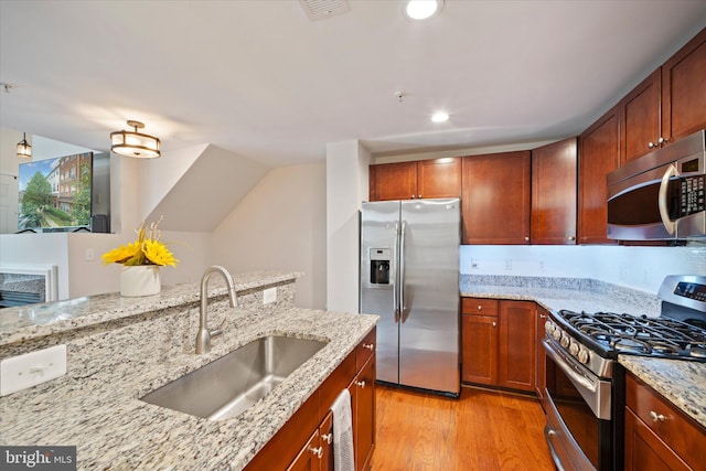 6124 Aster Haven Cir, Haymarket, VA 20169 - kitchen featuring appliances with stainless steel finishes, a sink, light stone countertops, light wood-type flooring, and recessed lighting