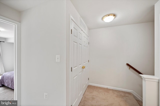 6124 Aster Haven Cir, Haymarket, VA 20169 - hallway with light carpet, an upstairs landing, and baseboards