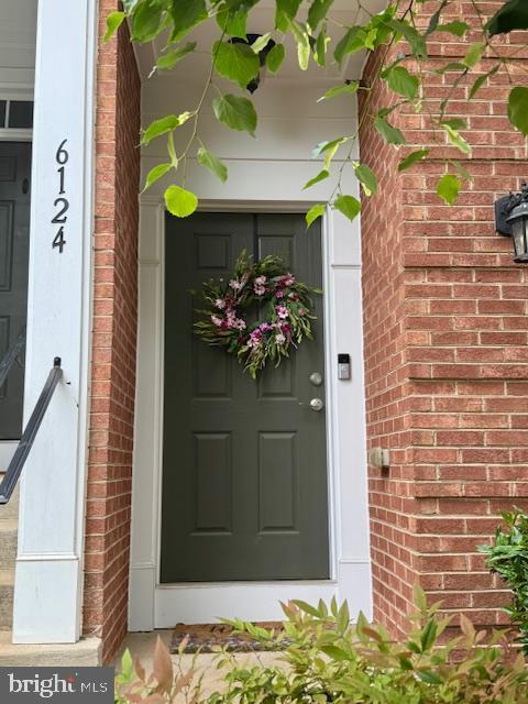 6124 Aster Haven Cir, Haymarket, VA 20169 - view of exterior entry featuring brick siding