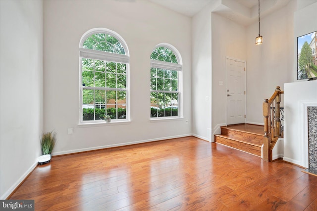 6124 Aster Haven Cir, Haymarket, VA 20169 - foyer entrance featuring healthy amount of natural light, wood-type flooring, baseboards, a towering ceiling, and stairway