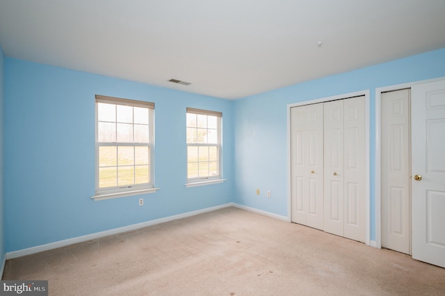 1310 Sheridan Pl Unit 108-17, Bel Air, MD 21015 - unfurnished bedroom featuring carpet, baseboards, and multiple closets