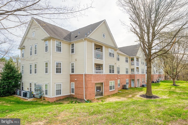1310 Sheridan Pl Unit 108-17, Bel Air, MD 21015 - view of home's exterior with cooling unit, brick siding, and a yard