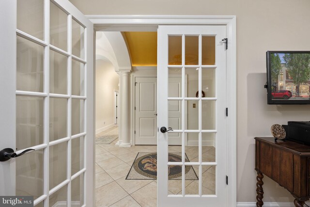 913A Caroline St, Fredericksburg, VA 22401 - hallway with french doors, arched walkways, tile patterned floors, and decorative columns