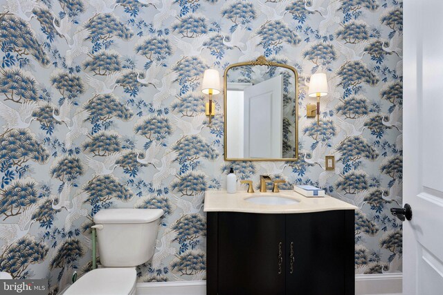 913A Caroline St, Fredericksburg, VA 22401 - bathroom with wallpapered walls, vanity, baseboards, and toilet