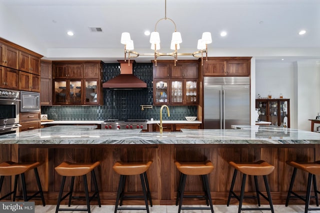 913A Caroline St, Fredericksburg, VA 22401 - kitchen with built in appliances, wall chimney range hood, backsplash, glass insert cabinets, and recessed lighting