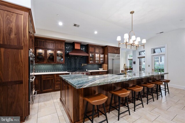 913A Caroline St, Fredericksburg, VA 22401 - kitchen with built in fridge, premium range hood, tasteful backsplash, a large island, and a chandelier