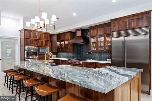 913A Caroline St, Fredericksburg, VA 22401 - kitchen featuring built in appliances, wall chimney exhaust hood, decorative backsplash, light tile patterned floors, and recessed lighting
