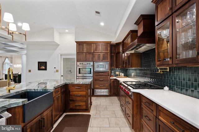 913A Caroline St, Fredericksburg, VA 22401 - kitchen featuring stainless steel appliances, lofted ceiling, a sink, tasteful backsplash, and custom exhaust hood