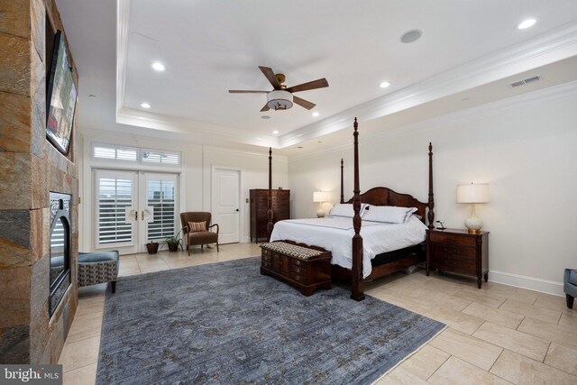 913A Caroline St, Fredericksburg, VA 22401 - bedroom featuring crown molding, a tray ceiling, light tile patterned floors, a fireplace, and baseboards