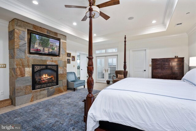 913A Caroline St, Fredericksburg, VA 22401 - tiled bedroom featuring a tiled fireplace, crown molding, recessed lighting, a tray ceiling, and french doors
