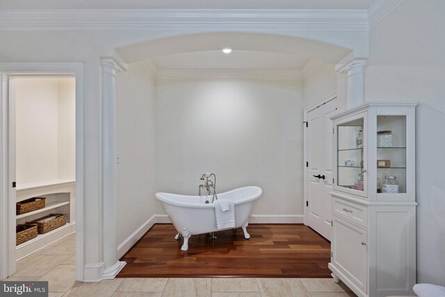 913A Caroline St, Fredericksburg, VA 22401 - full bathroom featuring ornate columns, a freestanding tub, crown molding, built in shelves, and baseboards