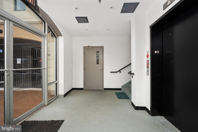 913A Caroline St, Fredericksburg, VA 22401 - hall featuring baseboards, stairs, elevator, and concrete flooring