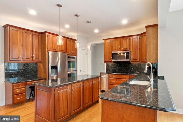 2 Turnberry Way, New Hope, PA 18938 - kitchen with stainless steel appliances, a sink, brown cabinets, a kitchen island, and recessed lighting