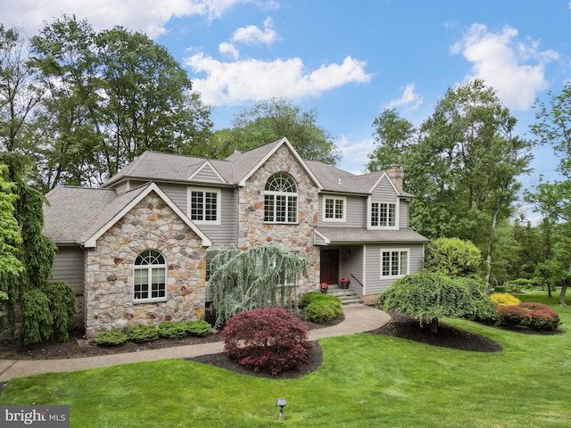 2 Turnberry Way, New Hope, PA 18938 - view of front of property featuring stone siding, a front lawn, a shingled roof, and a chimney