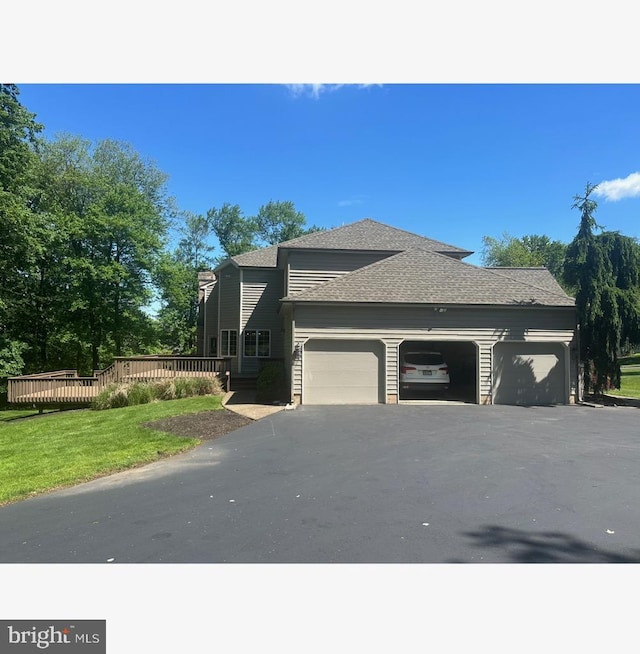 2 Turnberry Way, New Hope, PA 18938 - view of side of property featuring a garage, asphalt driveway, a shingled roof, a wooden deck, and a lawn