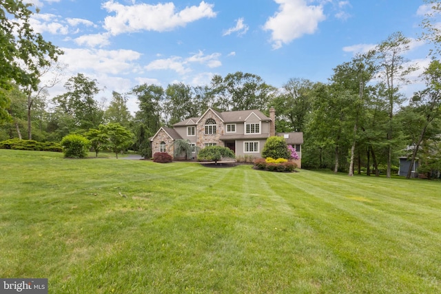 2 Turnberry Way, New Hope, PA 18938 - view of front of home featuring a front yard, a chimney, and stone siding