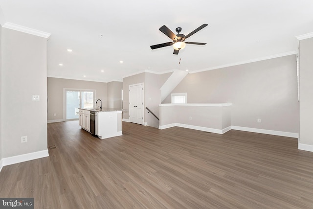 unfurnished living room with ceiling fan, ornamental molding, baseboards, wood finished floors, and recessed lighting