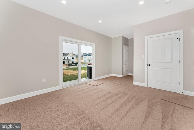 carpeted spare room with baseboards and recessed lighting