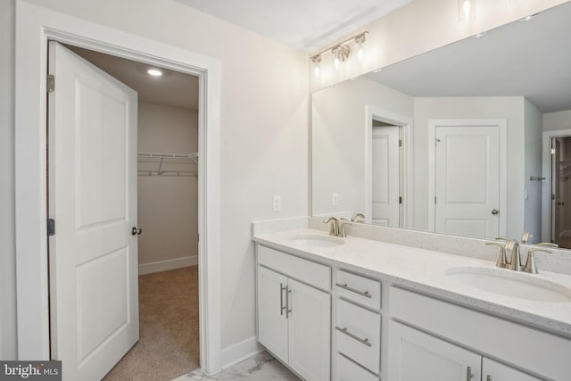 826 Long Meadow Dr, Fredericksburg, VA 22406 - bathroom with baseboards, double vanity, a spacious closet, and marble look tiles