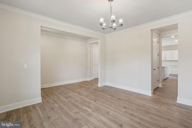 826 Long Meadow Dr, Fredericksburg, VA 22406 - spare room featuring a chandelier, light wood finished floors, baseboards, and ornamental molding