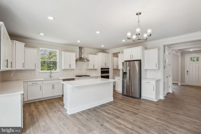 826 Long Meadow Dr, Fredericksburg, VA 22406 - kitchen with stainless steel fridge, wall chimney exhaust hood, a sink, ornamental molding, and gas stovetop