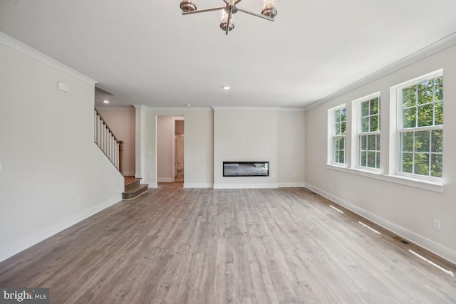 826 Long Meadow Dr, Fredericksburg, VA 22406 - unfurnished living room featuring ornamental molding, plenty of natural light, baseboards, wood finished floors, and stairs