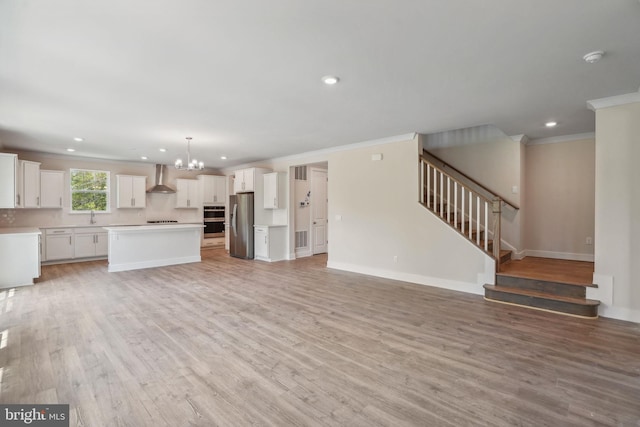 826 Long Meadow Dr, Fredericksburg, VA 22406 - unfurnished living room with ornamental molding, a chandelier, a sink, recessed lighting, and stairs