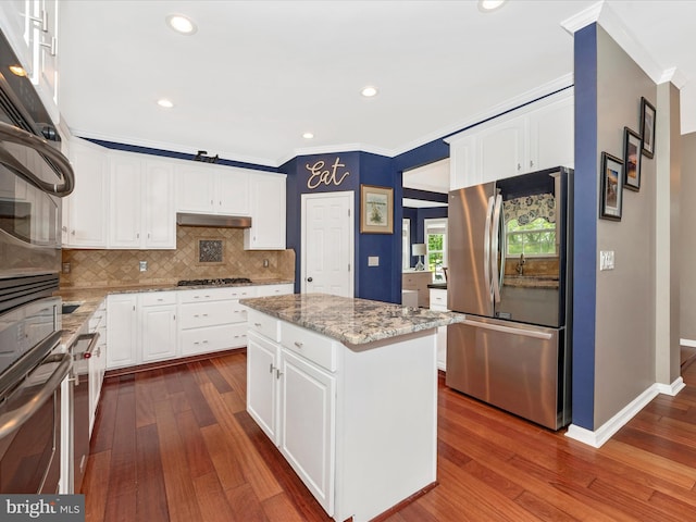 2619 Washington Way, Manchester, MD 21102 - kitchen with stainless steel appliances, ornamental molding, dark wood-style floors, tasteful backsplash, and white cabinets