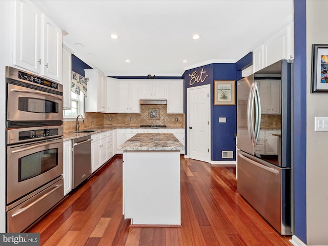 2619 Washington Way, Manchester, MD 21102 - kitchen featuring stainless steel appliances, a warming drawer, white cabinetry, crown molding, and a center island