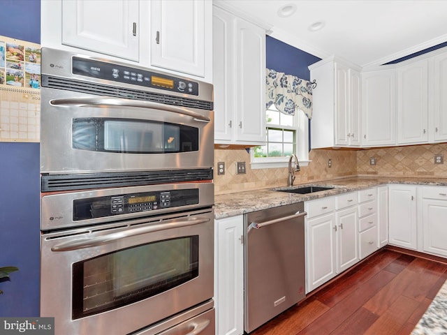 2619 Washington Way, Manchester, MD 21102 - kitchen featuring stainless steel appliances, a sink, dark wood finished floors, white cabinets, and decorative backsplash
