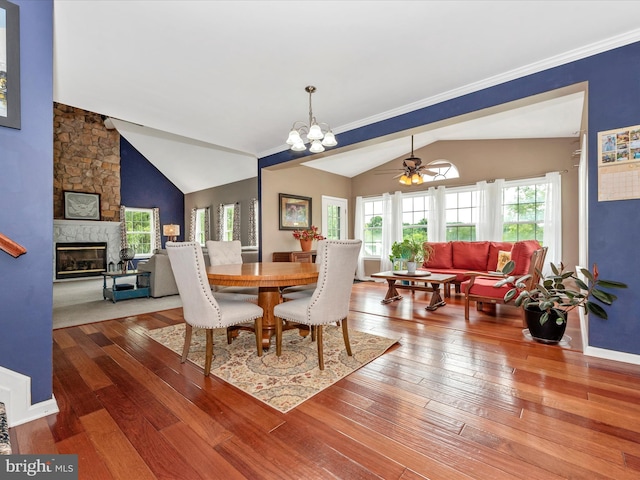 2619 Washington Way, Manchester, MD 21102 - dining space featuring lofted ceiling, hardwood / wood-style floors, a stone fireplace, a chandelier, and a ceiling fan