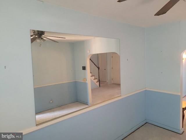 1605 Argonne Dr, Baltimore, MD 21218 - empty room featuring a ceiling fan, arched walkways, and stairs