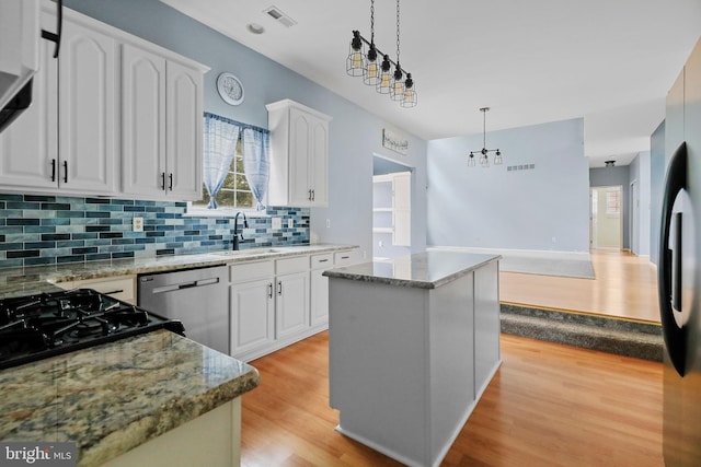 19 Pear Tree Pl, Sewell, NJ 08080 - kitchen featuring dishwasher, a sink, light wood-style flooring, tasteful backsplash, and white cabinets