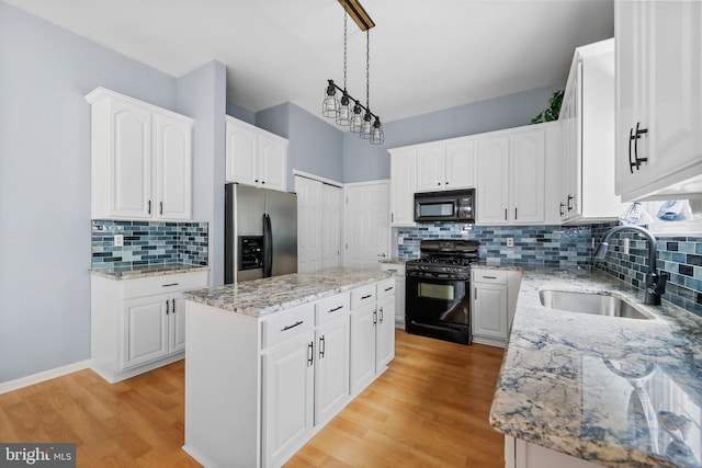 19 Pear Tree Pl, Sewell, NJ 08080 - kitchen featuring black appliances, a sink, backsplash, a center island, and light stone countertops