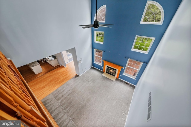 19 Pear Tree Pl, Sewell, NJ 08080 - unfurnished living room with a high ceiling, a fireplace with flush hearth, a ceiling fan, and baseboards