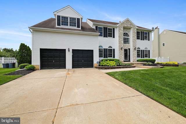 19 Pear Tree Pl, Sewell, NJ 08080 - view of front of property featuring a front lawn, driveway, stone siding, and an attached garage