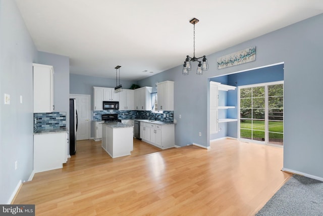 19 Pear Tree Pl, Sewell, NJ 08080 - kitchen featuring black appliances, tasteful backsplash, white cabinets, a center island, and light wood-style floors