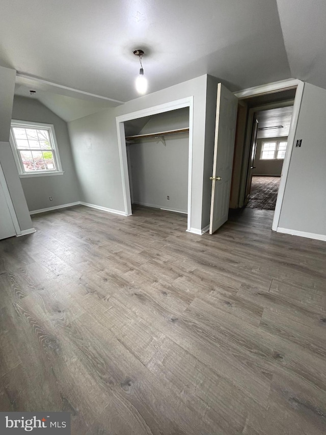325 Jencohallo Ave, Hamilton, NJ 08619 - unfurnished living room featuring baseboards, vaulted ceiling, and wood finished floors
