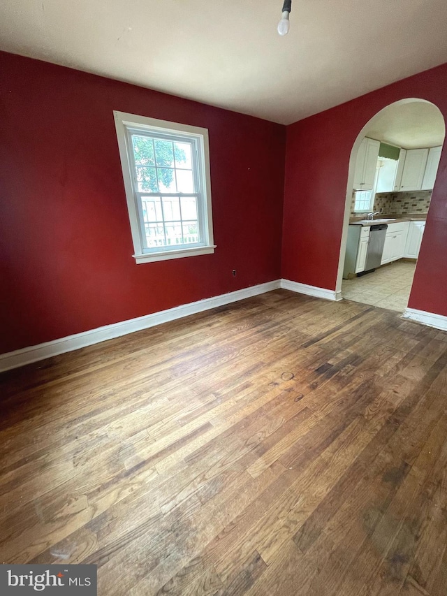 325 Jencohallo Ave, Hamilton, NJ 08619 - unfurnished room featuring arched walkways, wood finished floors, and baseboards