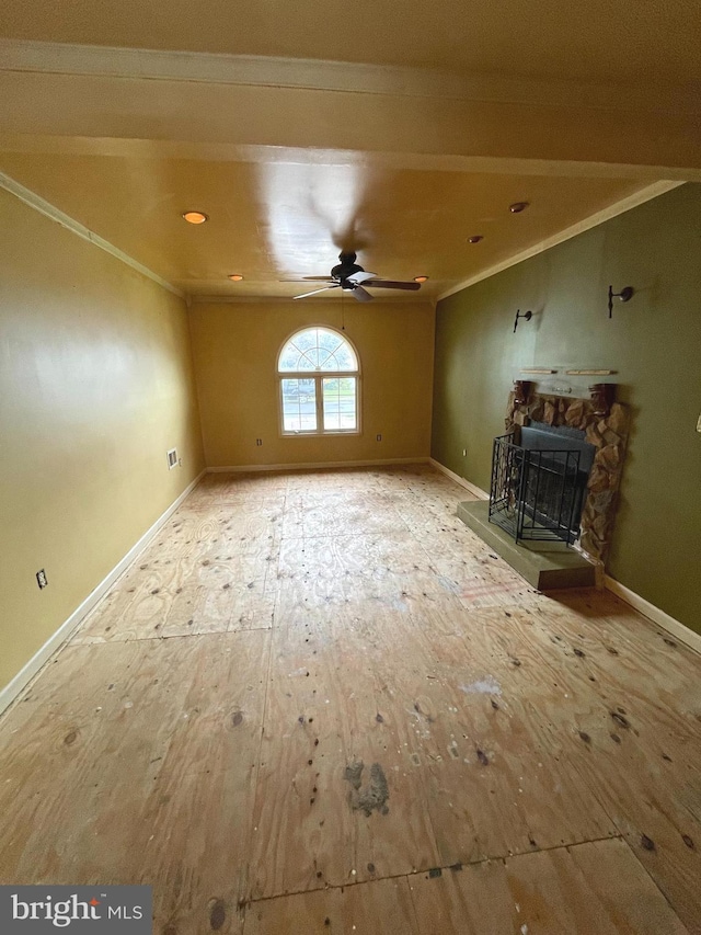 325 Jencohallo Ave, Hamilton, NJ 08619 - unfurnished living room featuring crown molding, a ceiling fan, a stone fireplace, and baseboards