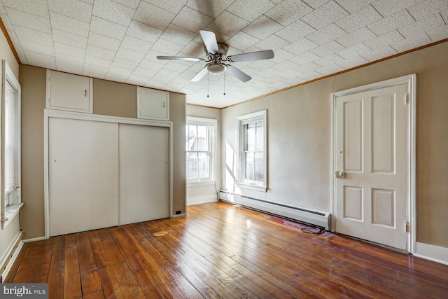 346 Main St, Denver, PA 17517 - unfurnished bedroom with baseboard heating, ornamental molding, hardwood / wood-style floors, a closet, and baseboards